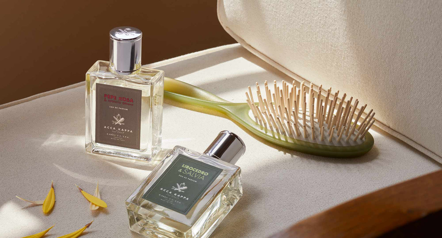 two womens fragrances and hair brush